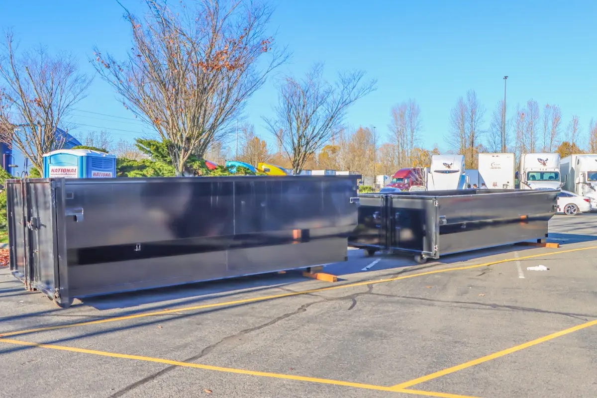 Professional dumpster rental service with roll-off container on residential driveway in Finneytown